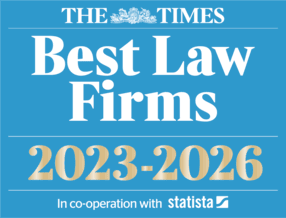 The logo has a sky-blue background consisting of four lines written in white and gold. The first line has The Times newspaper logo. The second line states "Best Law Firms" The third line is written in white and gold "2023-2025" . The fourth line prints "In co-operation with Statista" in small writing. 