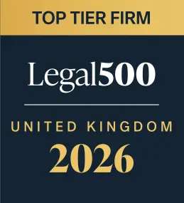 The logo has dark blue and golden background consisting of three sections written in dark blue, white and gold. The first section has typed top tier firm in capital letters. The second section states "Legal500". The third section says "United Kingdom 2025"