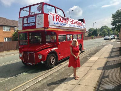 Mary Monson in front of the Trump Go Home bus